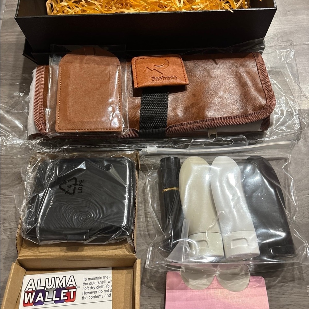 Brown travel case with 3 travel size bottles and black alumu wallet .